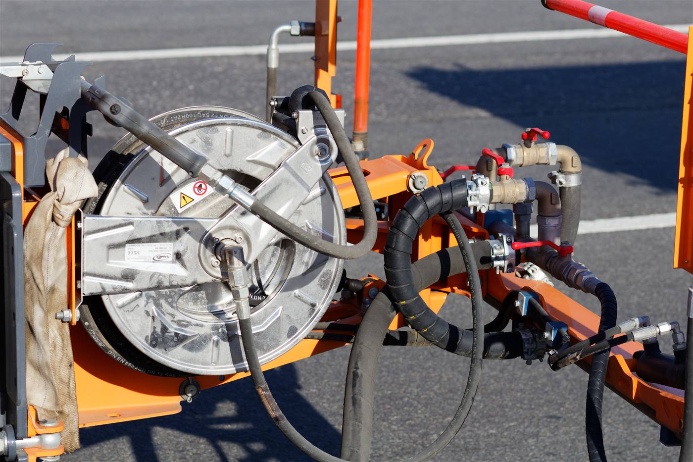 Hydraulic hose reel, lines and fittings on orange equipment